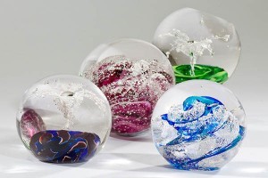Custom Urns: These glass globes allow families to have ashes blown into the glass for a truly customized memorial
