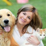 Young woman with dog and cat. The process for choosing pet urns and memorials begins here...